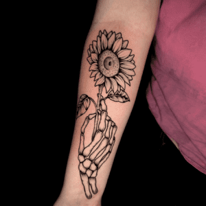 brooke dicken tattoo skeleton hand holding sunflower